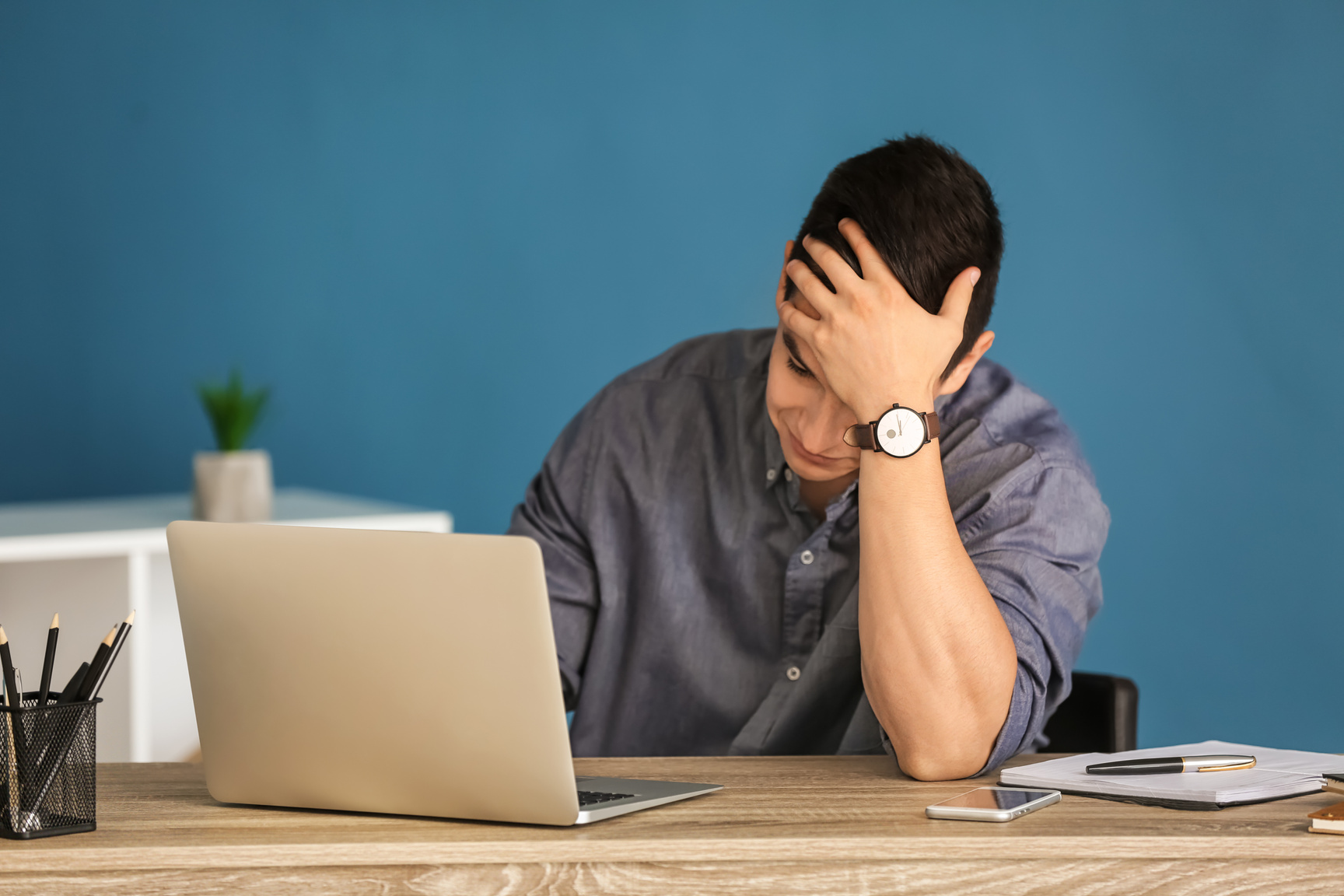 Young Troubled Freelancer Working on Laptop at Home