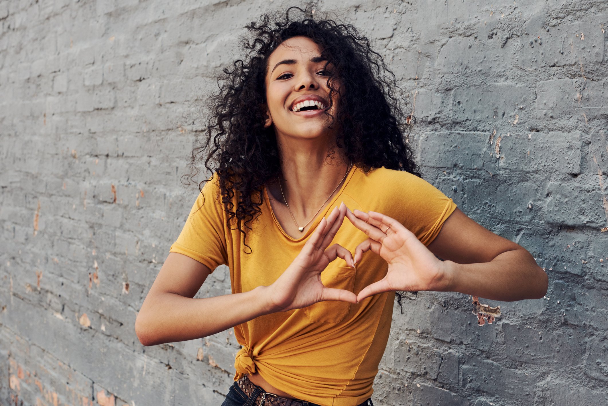 Happy Woman Doing Heart Hand Gesture